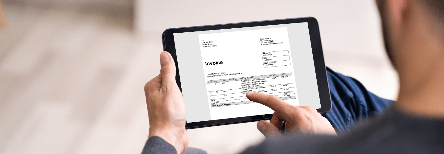 Invoice on an IPad with man holding it | Rea