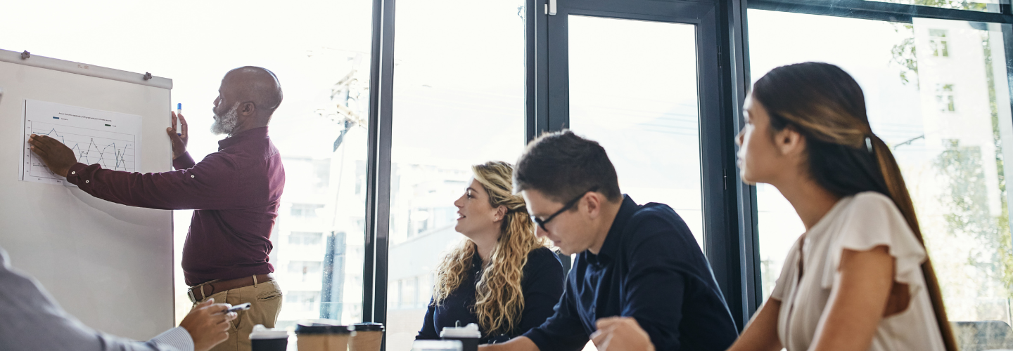 Group of Decision Makers Looking at a Board | Rea